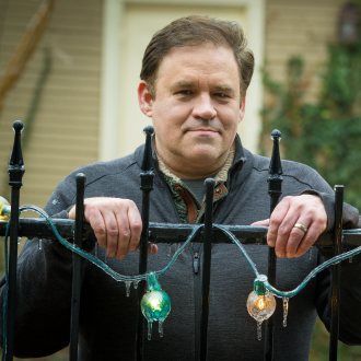 Close-up of Matthew Pitt outside near a fence.