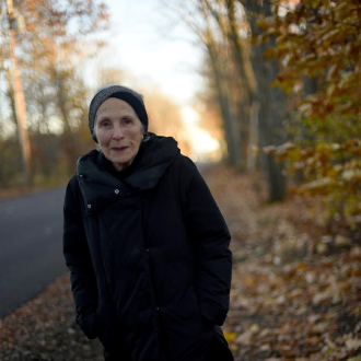 Close-up of Miriam Levine standing outside.