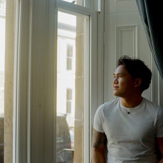 Close-up of Eric Tran looking out a window.
